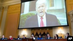 FILE - A video of President Donald Trump is shown on a screen, as the House select committee investigating the January 6 attack on the U.S. Capitol holds a hearing at the Capitol in Washington, July 21, 2022.