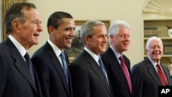 FILE - In this Jan. 7, 2009, photo, President George W. Bush, center, poses with President-elect Barack Obama, second left, and former presidents, George H.W. Bush, left, Bill Clinton, second right, and Jimmy Carter, right, in the Oval Office of the White