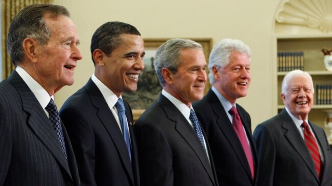 FILE - In this Jan. 7, 2009, photo, President George W. Bush, center, poses with President-elect Barack Obama, second left, and former presidents, George H.W. Bush, left, Bill Clinton, second right, and Jimmy Carter, right, at the White House.