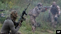 Volunteer soldiers attend training near Kyiv, Ukraine, Aug. 27, 2022. Fighters from Chechnya are participating on both sides of the conflict in Ukraine.