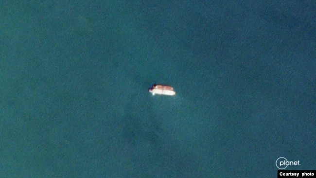 Two vessels identified by TankerTrackers.com as Iranian state-owned Polaris 1 (smaller tanker) and Rhine Shipping DMCC-operated Babel (larger tanker) engage in a ship-to-ship-transfer in waters off Iraq's Al-Faw peninsula, March 17, 2020 (Planet Labs)
