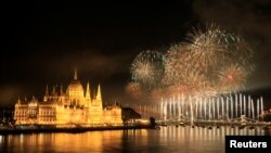 FILE - Fireworks explode over Danube River during Hungary's national holiday, St. Stephen's Day, in Budapest, Aug. 20, 2016. The 2022 fireworks were postponed because storms were forecast. 