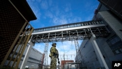 FILE - A Russian serviceman guards an area of the Zaporizhzhia Nuclear Power Station in territory under Russian military control, southeastern Ukraine, May 1, 2022. This pjoto
photo was taken during a trip organized by the Russian Ministry of Defense.