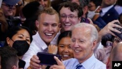 US President Joe Biden takes a photo with people after speaking at a rally hosted by the Democratic National Committee at Richard Montgomery High School, Aug. 25, 2022, in Rockville, Md.