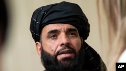 FILE - Suhail Shaheen, spokesman for the Taliban's political office in Doha, speaks to the media in Moscow, Russia on May 28, 2019.