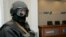 FILE - An armed man stands in the headquarters of Ukraine's state energy firm Naftogaz in Kiev, March 4, 2009.