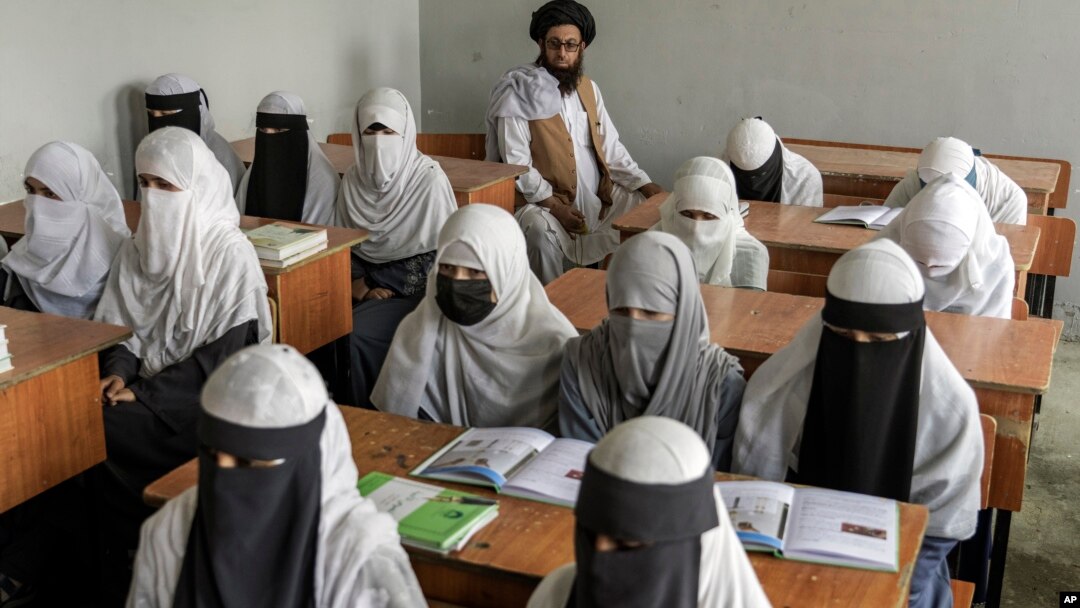 FILE - Afghan girls attend a religious school, which remained open since the Taliban's takeover more than two years ago, in Kabul, Afghanistan, Aug 11, 2022.