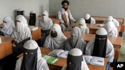FILE - Afghan girls attend a religious school, which remained open since the Taliban's takeover more than two years ago, in Kabul, Afghanistan, Aug 11, 2022.