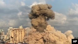 This image from a video shows smoke and dust rising from collapsing silos damaged during the August 2020 massive explosion in the port, in Beirut, Lebanon, Aug. 23, 2022. 