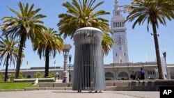 A made-to-order trash can called Salt and Pepper is seen near the Embarcadero and Ferry Building in San Francisco on July 26, 2022. Could it take years to make and costs more than $20,000? (AP Photo/Eric Risberg)