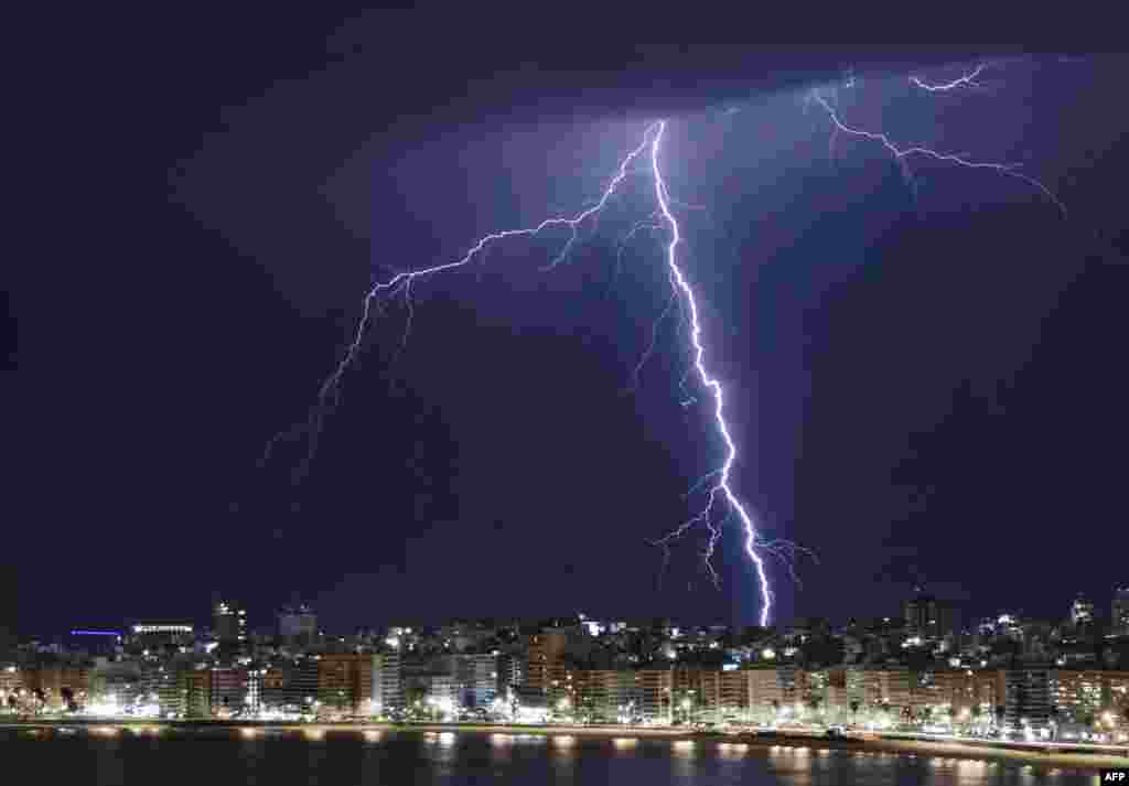 A lightning bolt strikes during a thunderstorm in Montevideo, Uruguay, Aug. 27, 2022. 