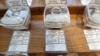 FILE - Samples of marijuana, in tamper-proof containers that are secured with cables, are displayed at Evergreen Cannabis, a marijuana retail shop, in Vancouver, British Columbia, Oct. 9, 2019.