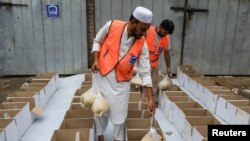Volunteers prepare food boxes to distribute among the flood victims, following rains and floods during the monsoon season in Peshawar, Pakistan, Aug. 26, 2022.