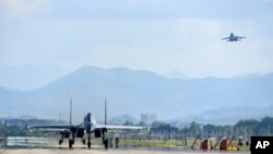 FILE - In this photo released by China's Xinhua News Agency, air force and naval aviation corps of the Eastern Theater Command of the Chinese People's Liberation Army (PLA) fly planes at an unspecified location in China, Aug. 4, 2022. 