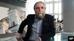 FILE - In this photo taken on Aug. 11, 2016, Aleksander Dugin, the Russian political commentator, sits in his TV studio in central Moscow.