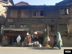 A woman makes purchases from a traditional shops in a building in the Habba Kadal area of Srinagar, Jammu and Kashmir in Indian-administered Kashmir. (M. Hamid/VOA)