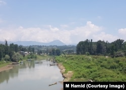 People in boats mining sand in one of the tributaries of Jhelum in Anantnag district of Kashmir.