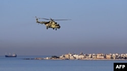 FILE - A Russian Mi-28 helicopter flies off the coast of the Syrian port city of Tartus, July 25, 2022. Syrian state media said air defense forces were confronting an Israeli attack aimed at targets in the vicinity of the Syrian coastal province of Tartus