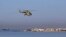 FILE - A Russian Mi-28 helicopter flies off the coast of the Syrian port city of Tartus, July 25, 2022. Syrian state media said air defense forces were confronting an Israeli attack aimed at targets in the vicinity of the Syrian coastal province of Tartus