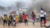 People run away during an anti-government protest in Freetown, Sierra Leone, August 10, 2022 in this picture obtained from social media. 