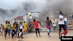 People run away during an anti-government protest in Freetown, Sierra Leone, August 10, 2022 in this picture obtained from social media. 