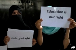 FILE - Afghan girls hold illegal protest to demand the right to education in a private home in Kabul, Afghanistan, Tuesday, Aug. 2, 2022. (AP Photo/Ebrahim Noroozi)