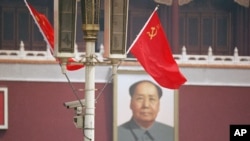 The Soviet flag frames the portrait of Mao Tse-tung in Beijing's Tiananmen Square as President Mikhail Gorbachev arrived in Beijing on May 15, 1989.
