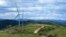Tourists ride horses near Wind turbines on the grassland in Zhangbei county, in north China's Hebei province on Aug. 15, 2022. 