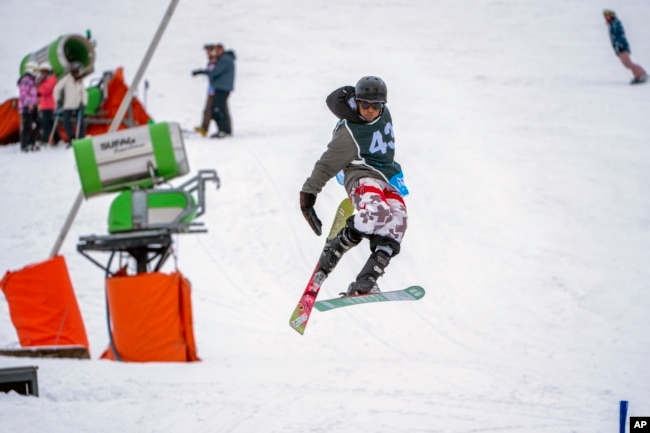 Sekholo Ramonotsi, 13, competes in the Winter Whip Slopestyle snowboard and ski competition at the Afriski ski resort near Butha-Buthe, Lesotho, Saturday July 30, 2022. (AP Photo/Jerome Delay)