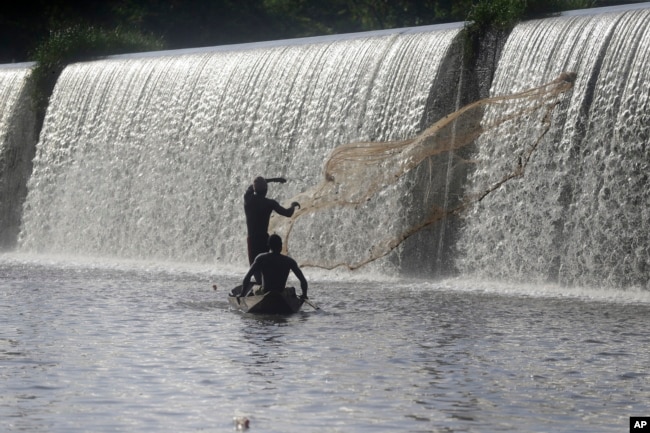 Fishermen cast a net near a dam that sources the sacred Osun River in Esa-Odo, Nigeria, on May 28, 2022.
