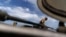 A Ukrainian serviceman stands on top of a tank while taking a break during training with his unit in the Donetsk region, eastern Ukraine, Monday, August 22, 2022
