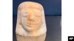 FILE- Photo by U.S. Customs and Border Protection of an Egyptian canopic jar lid of the funeral deity, Imsety, seized by agents in Memphis that was shipped in from Europe, Aug. 17, 2022.