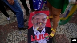 An image of former Brazilian President Luiz Inacio Lula da Silva lays on the ground during a campaign rally for his rival, current President Jair Bolsonaro, in Juiz de Fora, Minas Gerais state, Brazil, Aug. 16, 2022.