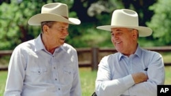 FILE - Former President Ronald Reagan, left, and former Soviet President Mikhail Gorbachev don cowboy hats while enjoying a moment at Reagan's Rancho del Cielo north of Santa Barbara, Calif, on May 2, 1992.