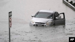 Một chiếc xe nằm trong nước lũ nhấn chìm một đường cao tốc ở thành phố Dallas, bang Texas, ngày 22 tháng 8 năm 2022.