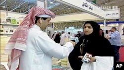 In this frame grab from Saudi state television footage, doctoral student and women's rights advocate Salma al-Shehab speaks to a journalist at the Riyadh International Book Fair in Riyadh, Saudi Arabia, in March 2014.