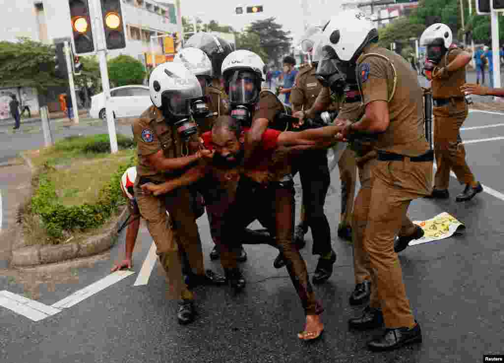 Sri Lankan police officers detain a demonstrator during an anti-government protest by Inter-University Student&#39;s Federation, amid the country&#39;s economic crisis, in Colombo.