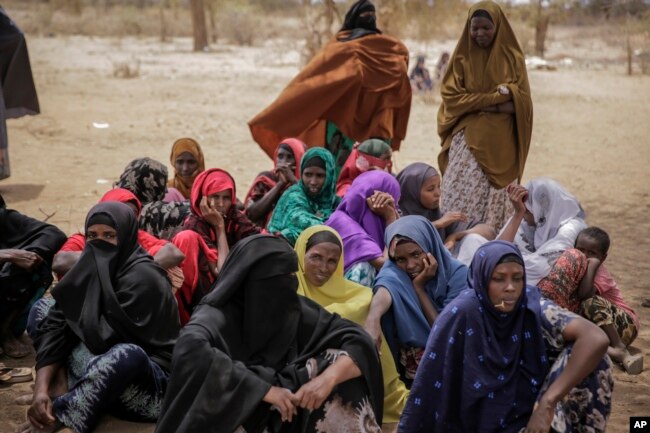 Villagers gather during a visit by World Food Program chief David Beasley, in the village of Wagalla in northern Kenya Friday, Aug. 19, 2022. (AP Photo/Brian Inganga)