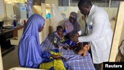 Dr. Japhet Udokwu attends to a child at a treatment center for severely malnourished children in Damaturu, Yobe, Nigeria, Aug. 24, 2022.
