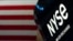 FILE - An NYSE sign is seen on the floor at the New York Stock Exchange in New York, June 15, 2022. 
