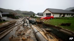A road is washed away in Nelson, New Zealand, Aug. 18, 2022. Heavy rain continued to pelt New Zealand, causing further disruptions and road closures from a storm that already forced hundreds to evacuate their homes. (George Heard/New Zealand Herald via AP)