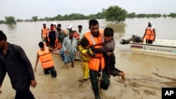 Army troops evacuate people from a flood-hit area in Rajanpur, district of Punjab, Pakistan, Aug. 27, 2022. Officials say flash floods triggered by heavy monsoon rains across much of Pakistan have killed nearly 1,000 people and displaced thousands more si