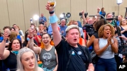 FILE - People cheer at a watch party in Overland Park, Kan., after learning that voters had rejected a state constitutional amendment that would have allowed the Legislature to restrict or ban abortion, Aug. 2, 2022.