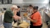 Volunteers at the American Indian Center of Chicago help chef Jessica Pamonicutt, second from left, prepare a contemporary Indigenous meal for seniors on Aug. 3, 2022. A fusion of Southwestern and Northern Indigenous ingredients, the spread includes turke