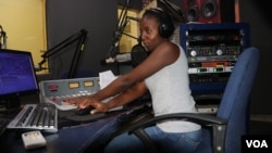 FILE - Radio Presenter Florence Mwale sits in the on-air studio at Capital FM in this undated photo. (Lameck Masina/VOA)