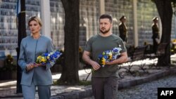 This handout photo taken and released by the Ukrainian presidential press service on Aug. 24, 2022, shows Ukrainian President Volodymyr Zelenskyy and his wife Olena attending a commemoration ceremony in Kyiv for Ukrainians killed since Russia invaded.