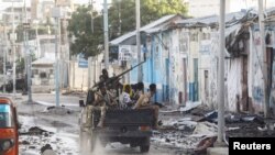 Somali security officers drive past a section of Hotel Hayat, the scene of an al Qaeda-linked al Shabaab group militant attack in Mogadishu, Somalia. (File)