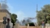 Smoke billows as rival Libyan groups exchange fire in the capital Tripoli, Aug. 27, 2022. 