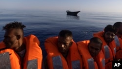 Migrants are being rescued by volunteers of the 'Ocean Viking', a migrant search and rescue ship run by NGOs SOS Mediterranee and the International Federation of Red Cross, Aug. 27, 2022, some 26 nautical miles south of the Italian Lampedusa island. 