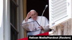 Pope Francis leads Angelus prayer from window at the Vatican in Vatican City, Aug. 21, 2022. 